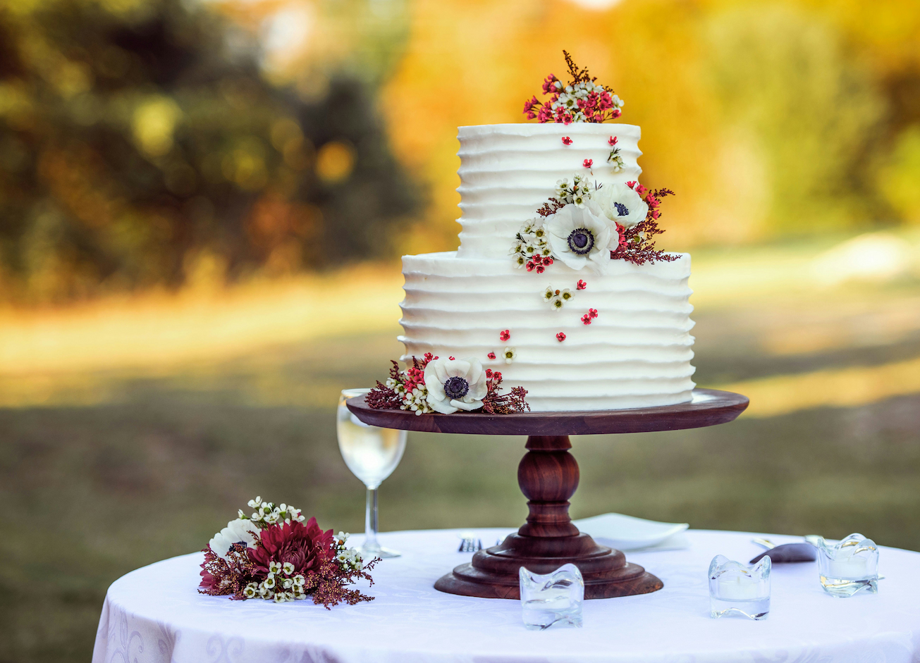 Wedding cake with white frosting at an outdoor wedding